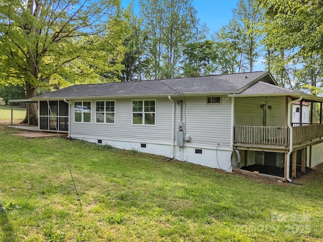 back of house with crawl space, a sunroom, a yard, a deck, and a shingled roof