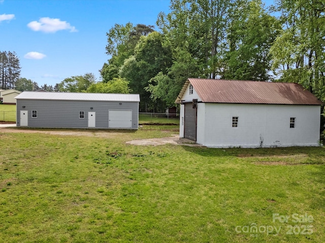 view of yard with a garage and an outdoor structure