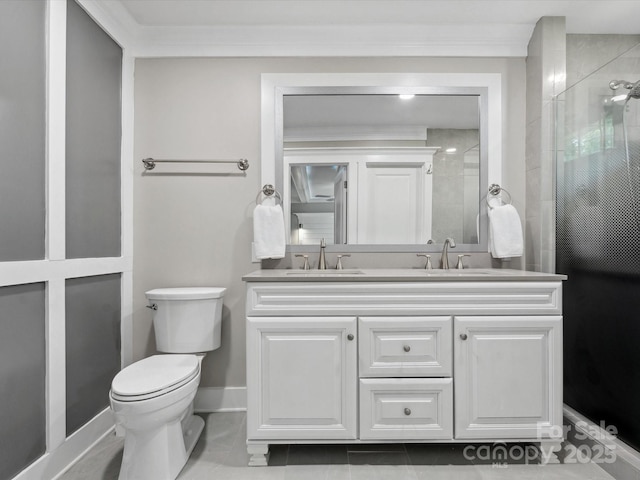full bath with toilet, double vanity, a tile shower, and baseboards