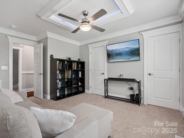 living area featuring ceiling fan, carpet floors, ornamental molding, and baseboards