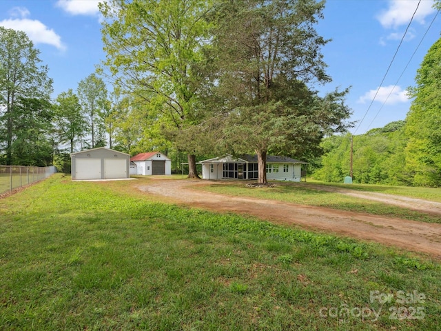 view of yard featuring a garage and an outdoor structure