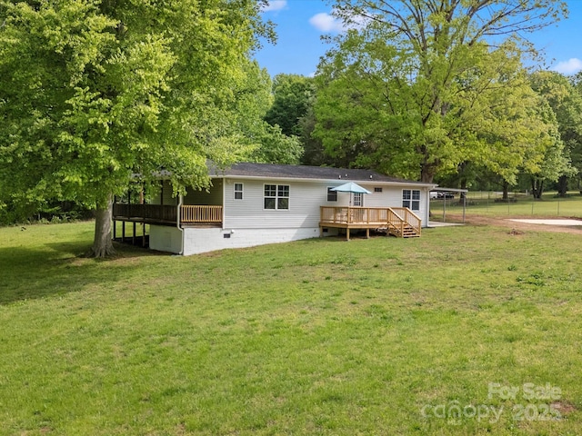 rear view of house with a deck, crawl space, and a carport