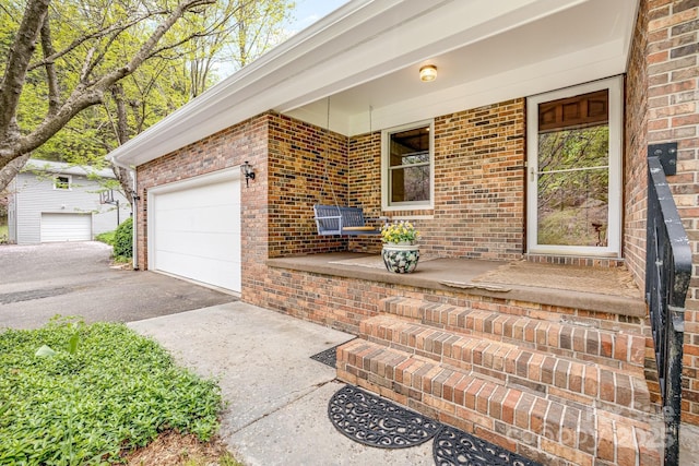 6334 Jacks Creek Rd, Burnsville, NC 28714 - doorway to property with asphalt driveway, brick siding, a porch, and an attached garage