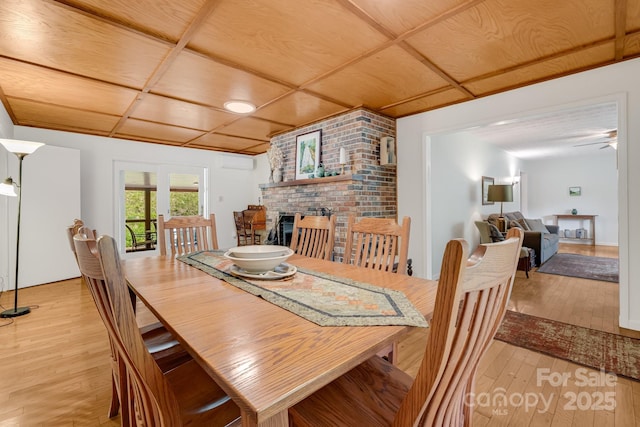 6334 Jacks Creek Rd, Burnsville, NC 28714 - dining space with light wood-style flooring, a fireplace, wooden ceiling, and a wall unit AC