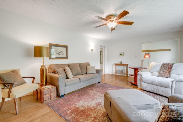 6334 Jacks Creek Rd, Burnsville, NC 28714 - living area featuring light wood finished floors, ceiling fan, and a textured ceiling