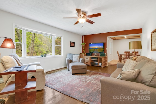 6334 Jacks Creek Rd, Burnsville, NC 28714 - living area with a ceiling fan, wood finished floors, and baseboards