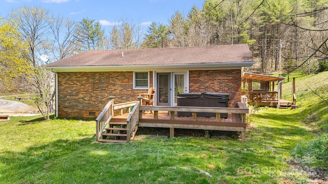 6334 Jacks Creek Rd, Burnsville, NC 28714 - back of house featuring brick siding, a wooden deck, and a hot tub
