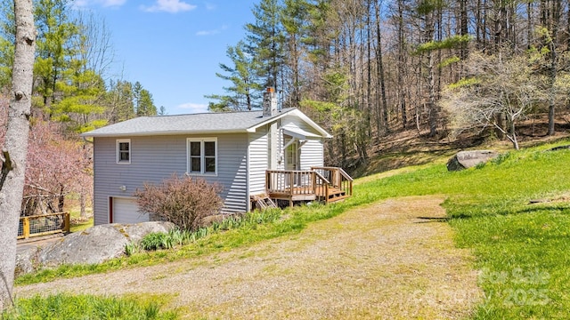 6334 Jacks Creek Rd, Burnsville, NC 28714 - view of property exterior featuring an attached garage, a chimney, and a shingled roof
