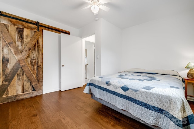 6334 Jacks Creek Rd, Burnsville, NC 28714 - bedroom with a barn door, wood finished floors, and a ceiling fan