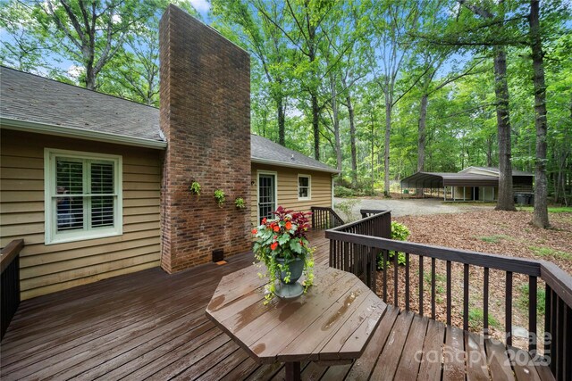 wooden deck with a detached carport