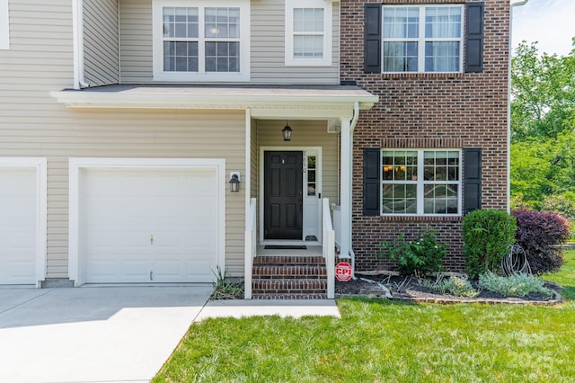 7650 W Berkeley Rd, Denver, NC 28037 - view of exterior entry featuring driveway, a garage, brick siding, and a lawn