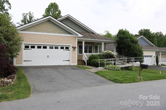 ranch-style house featuring driveway, an attached garage, a porch, and a front yard
