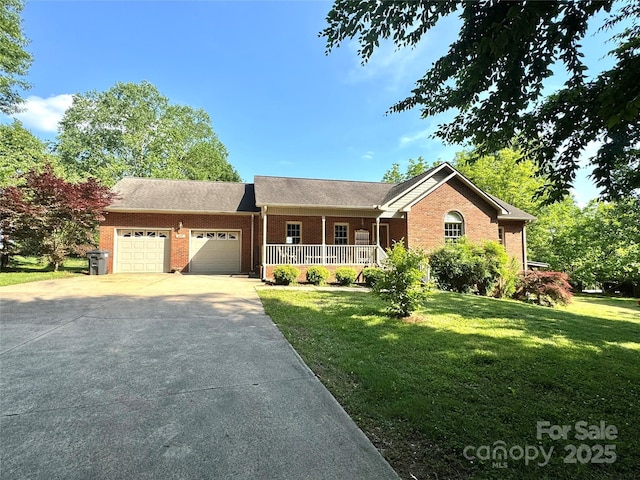 ranch-style house with a porch, brick siding, a garage, a front yard, and driveway