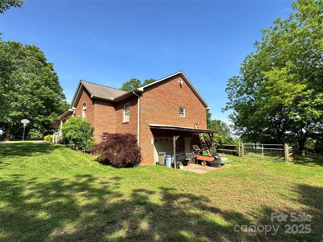 back of property featuring brick siding and a garage
