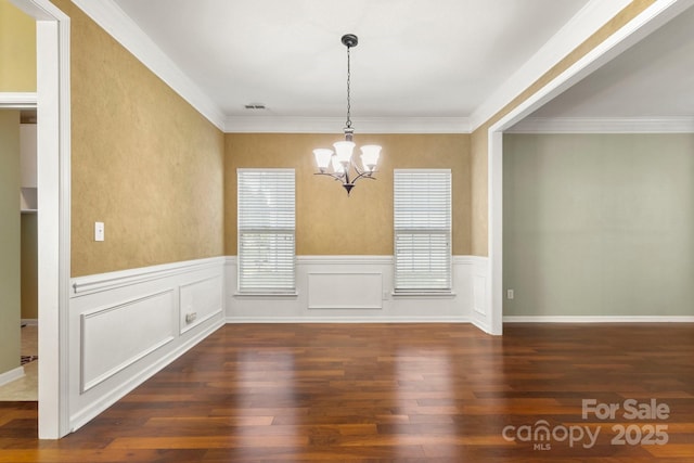 12824 Harvest Time Ct, Charlotte, NC 28278 - unfurnished dining area featuring a chandelier, wood finished floors, a wainscoted wall, and crown molding