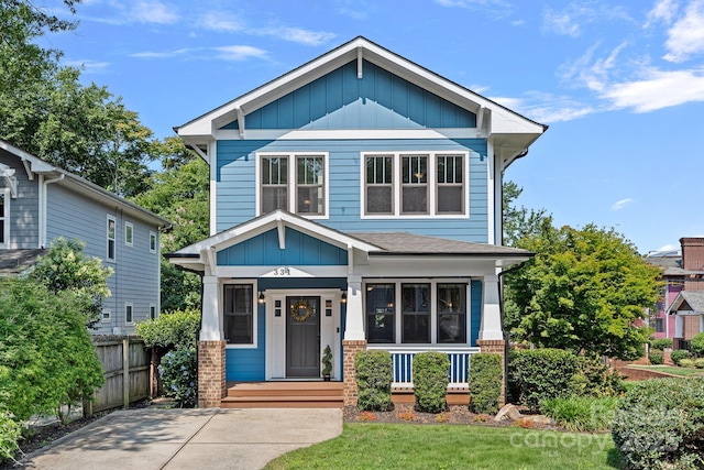 331 Solomon St, Charlotte, NC 28216 - view of front of property featuring board and batten siding, covered porch, and brick siding