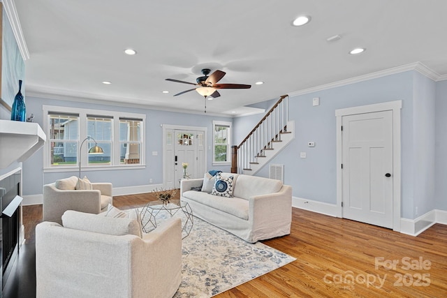 331 Solomon St, Charlotte, NC 28216 - living area with stairs, ornamental molding, ceiling fan, recessed lighting, and baseboards