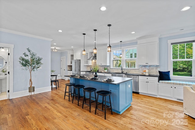 331 Solomon St, Charlotte, NC 28216 - kitchen with stainless steel appliances, a sink, a kitchen bar, dark countertops, and white cabinetry