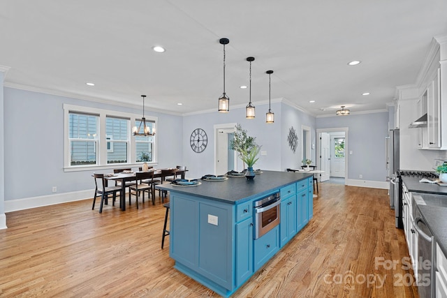 331 Solomon St, Charlotte, NC 28216 - kitchen with blue cabinetry, dark countertops, stainless steel appliances, recessed lighting, and baseboards