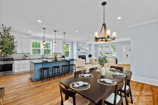 331 Solomon St, Charlotte, NC 28216 - dining space with recessed lighting, healthy amount of natural light, a chandelier, light wood finished floors, and crown molding