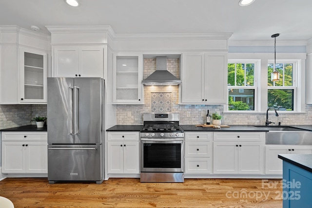 331 Solomon St, Charlotte, NC 28216 - kitchen featuring appliances with stainless steel finishes, wall chimney exhaust hood, dark countertops, white cabinetry, and a sink