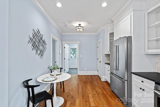 331 Solomon St, Charlotte, NC 28216 - kitchen with high end refrigerator, glass insert cabinets, white cabinets, crown molding, and backsplash