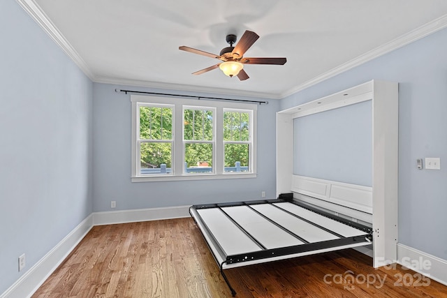 331 Solomon St, Charlotte, NC 28216 - unfurnished bedroom featuring wood finished floors, ornamental molding, baseboards, and ceiling fan