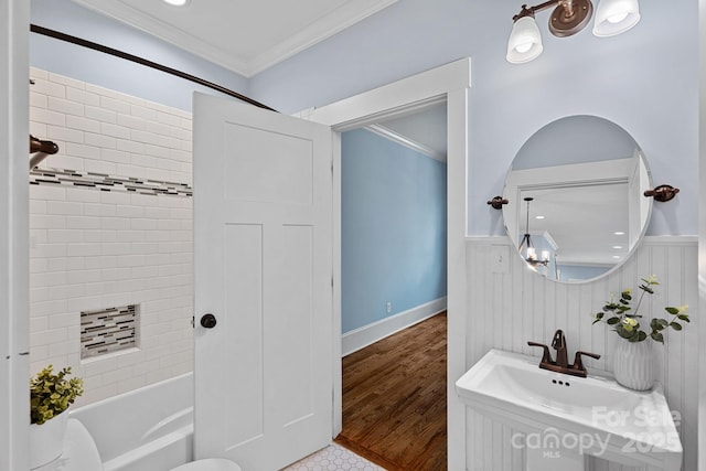 331 Solomon St, Charlotte, NC 28216 - full bathroom with ornamental molding, a wainscoted wall, shower / tub combination, a sink, and wood finished floors