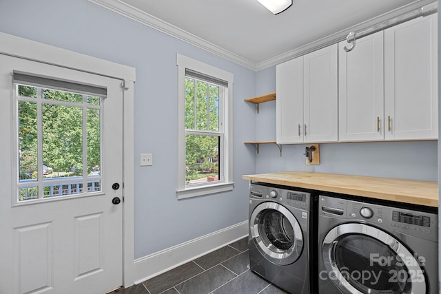331 Solomon St, Charlotte, NC 28216 - washroom featuring cabinet space, washer and clothes dryer, baseboards, crown molding, and dark tile patterned floors