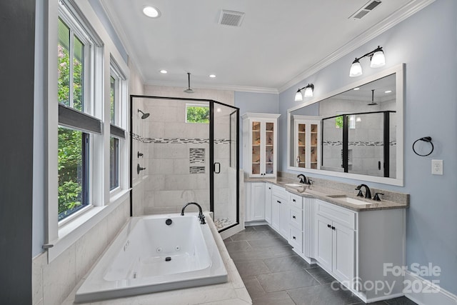 331 Solomon St, Charlotte, NC 28216 - bathroom featuring a shower stall, a tub with jets, double vanity, crown molding, and recessed lighting