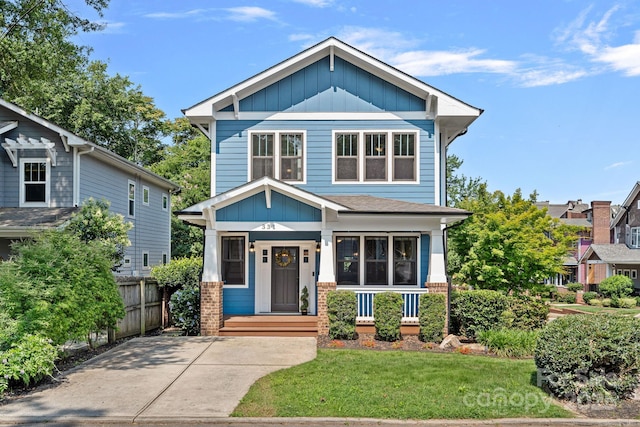 331 Solomon St, Charlotte, NC 28216 - view of front facade with board and batten siding, a porch, and brick siding