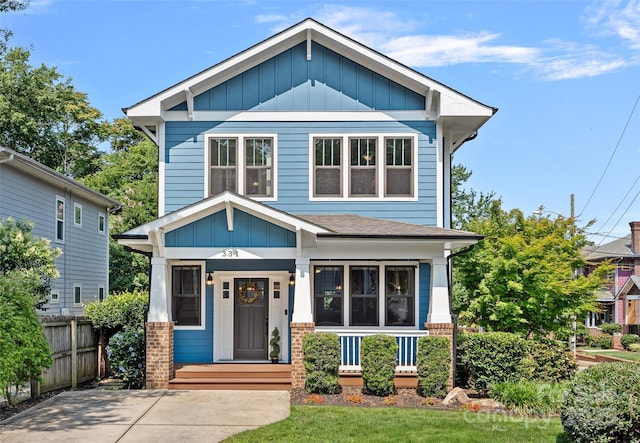 331 Solomon St, Charlotte, NC 28216 - view of front of home featuring board and batten siding, brick siding, covered porch, and roof with shingles