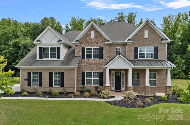 2185 Loire Valley Dr, Fort Mill, SC 29707 - craftsman-style home featuring brick siding, a front yard, and a shingled roof