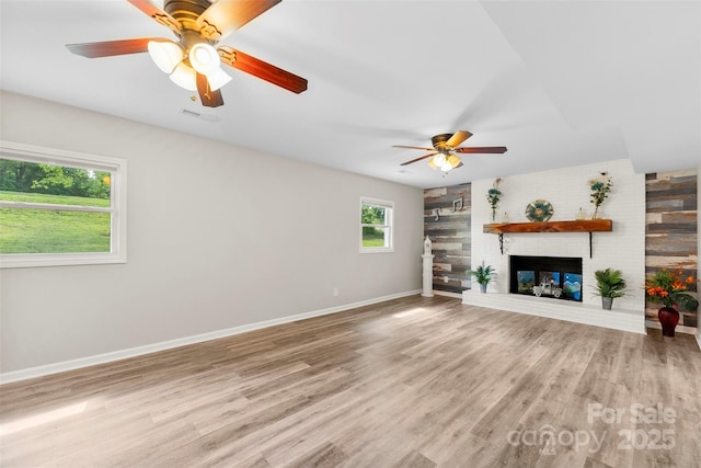 1822 N New Hope Rd, Gastonia, NC 28054 - unfurnished living room featuring ceiling fan, wood finished floors, baseboards, and a brick fireplace