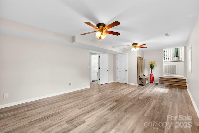 1822 N New Hope Rd, Gastonia, NC 28054 - unfurnished living room featuring a ceiling fan, light wood-type flooring, and baseboards