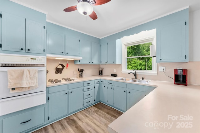 1822 N New Hope Rd, Gastonia, NC 28054 - kitchen with white appliances, a warming drawer, a sink, a ceiling fan, and blue cabinetry