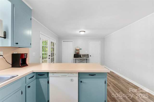 1822 N New Hope Rd, Gastonia, NC 28054 - kitchen with dishwasher, a peninsula, wood finished floors, light countertops, and ornamental molding