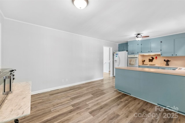 1822 N New Hope Rd, Gastonia, NC 28054 - kitchen featuring white appliances, blue cabinets, light countertops, light wood-type flooring, and ceiling fan