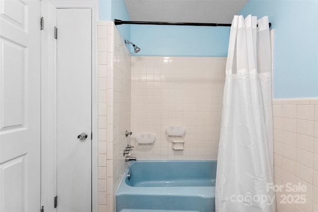 1822 N New Hope Rd, Gastonia, NC 28054 - bathroom featuring shower / tub combo with curtain, a textured ceiling, wainscoting, and tile walls