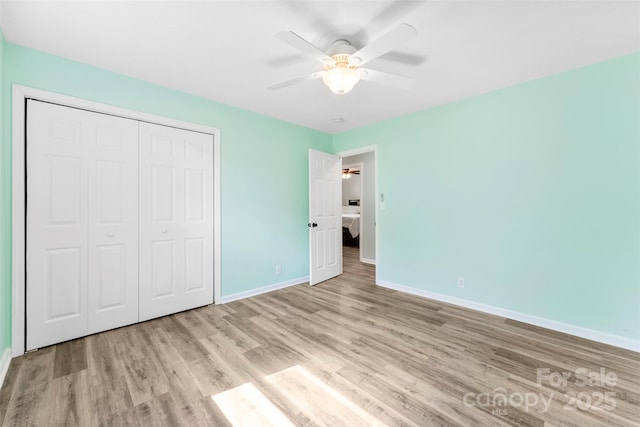 1822 N New Hope Rd, Gastonia, NC 28054 - unfurnished bedroom with wood finished floors, baseboards, a closet, and a ceiling fan
