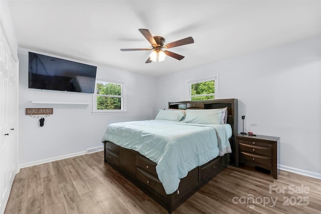 1822 N New Hope Rd, Gastonia, NC 28054 - bedroom featuring wood finished floors, multiple windows, and baseboards