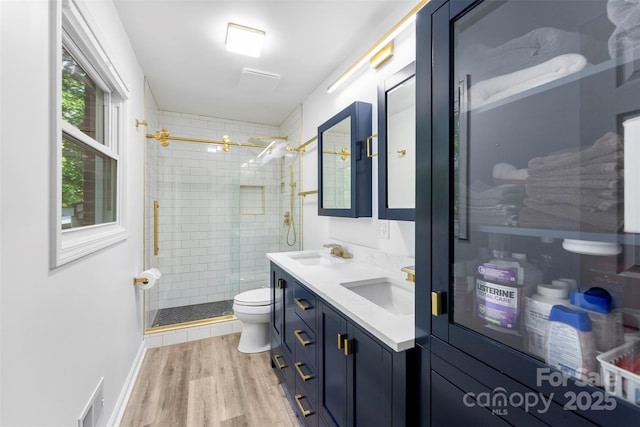 1822 N New Hope Rd, Gastonia, NC 28054 - full bathroom with toilet, a stall shower, wood finished floors, and double vanity
