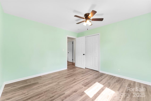 1822 N New Hope Rd, Gastonia, NC 28054 - unfurnished bedroom with wood finished floors, baseboards, a closet, and ceiling fan