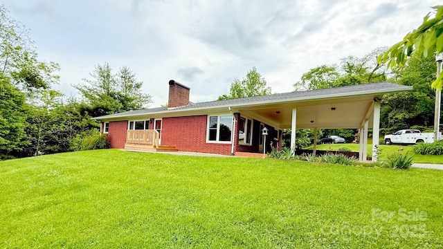 147 Forest Hill Dr, West Jefferson, NC 28694 - rear view of house with a chimney, a lawn, and brick siding