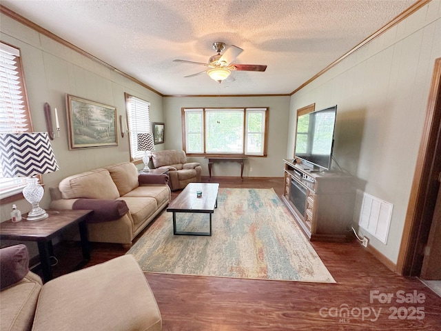 211 Spruce St, Badin, NC 28009 - living area with crown molding, a ceiling fan, a textured ceiling, wood finished floors, and baseboards