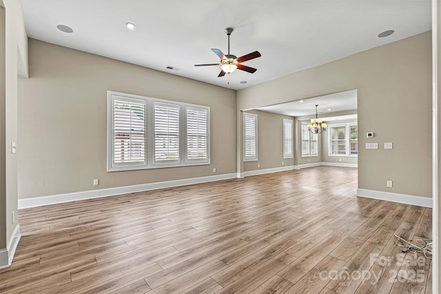 7362 Overjoyed Xing, Charlotte, NC 28215 - unfurnished living room featuring a chandelier, light wood-type flooring, a ceiling fan, baseboards, and recessed lighting