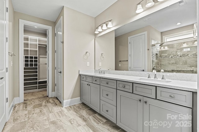 7362 Overjoyed Xing, Charlotte, NC 28215 - full bathroom with double vanity, a stall shower, a walk in closet, and baseboards