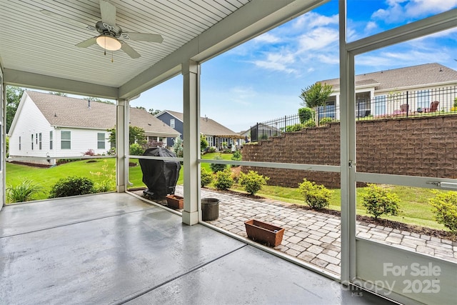 7362 Overjoyed Xing, Charlotte, NC 28215 - unfurnished sunroom with ceiling fan, healthy amount of natural light, and a residential view