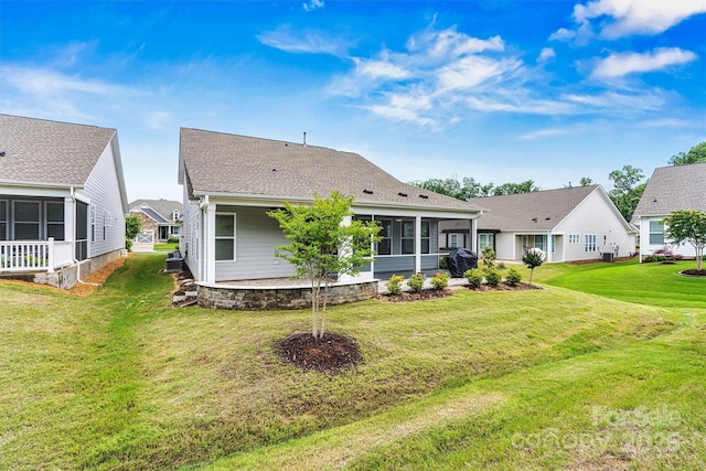 7362 Overjoyed Xing, Charlotte, NC 28215 - back of house with a sunroom, a lawn, and a shingled roof