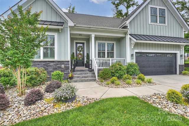 562 Preservation Dr, Fort Mill, SC 29715 - view of front of home with board and batten siding, a standing seam roof, a porch, metal roof, and driveway